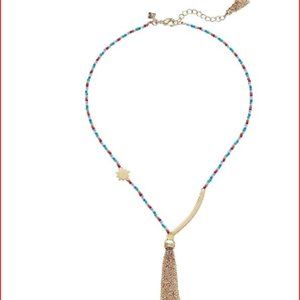 Candy-colored seed beads suspend brushed golden charms and a breezy chain tassel